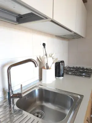 a kitchen counter with a sink and a stove at TOP POOL VIEW - Tropical Apt B11 - PointingCaboVerde in Santa Maria