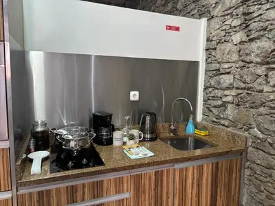 a kitchen counter with a sink and a stove at Techas City Center Luxe Suites in Praia