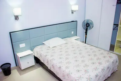 a bedroom with a bed and a fan at Morabeza & Mar in Porto Novo