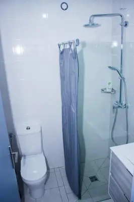 a bathroom with a toilet and a glass shower at Morabeza & Mar in Porto Novo