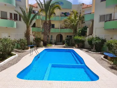 a swimming pool in front of a building at Capo Verde Club - Ca Matteo in Santa Maria