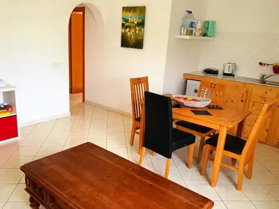 a kitchen and dining room with a wooden table and chairs at Capo Verde Club - Ca Matteo in Santa Maria