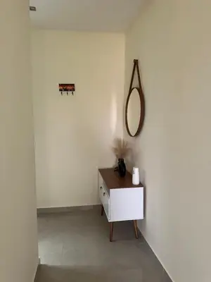 a white room with a mirror and a dresser at T1 Mindelo City Center in Mindelo