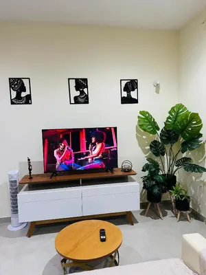 a living room with a flat screen tv on a white wall at T1 Mindelo City Center in Mindelo