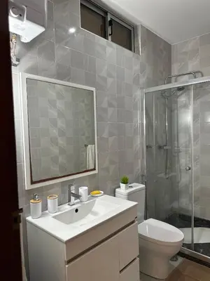 a bathroom with a sink and a shower and a toilet at T1 Mindelo City Center in Mindelo