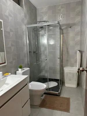 a bathroom with a shower and a toilet and a sink at T1 Mindelo City Center in Mindelo