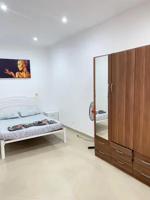 a bedroom with a bed and a dresser and a mirror at Mar Azul Tarrafal APARTMENT in Tarrafal