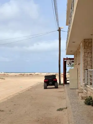 a jeep parked next to a building on the beach at Wave Studio in Sal Rei