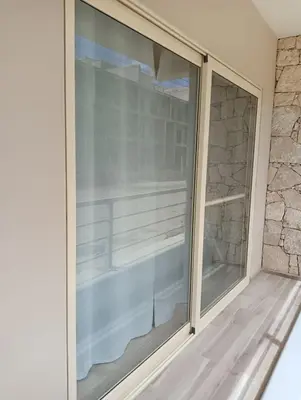 a sliding glass door in a room with a stone wall at Wave Studio in Sal Rei