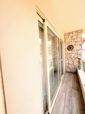 a hallway with a glass door and a stone wall at Wave Studio in Sal Rei
