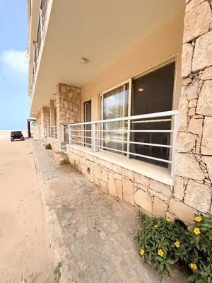 a balcony of a house with a window and flowers at Wave Studio in Sal Rei