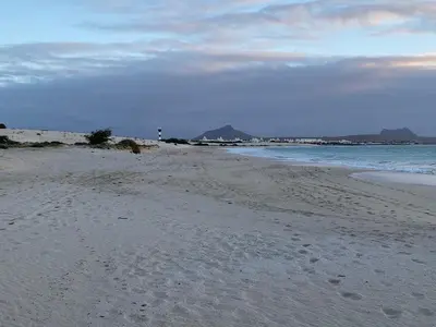 a beach with footprints in the sand and the ocean at Beachapartment fully serviced in Sal Rei