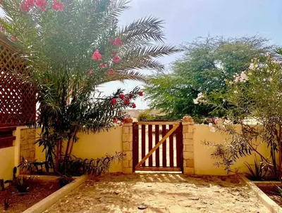 a fence with a gate and some trees and flowers at Beachapartment fully serviced in Sal Rei