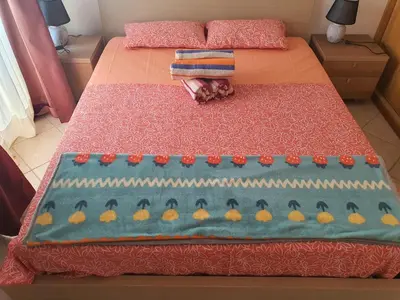 a cake on a bed with fruit on it at Capo Verde Club - Ca Francesca in Santa Maria