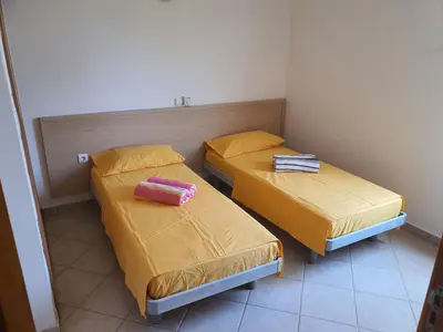 two beds in a small room with yellow sheets at Capo Verde Club - Ca Francesca in Santa Maria