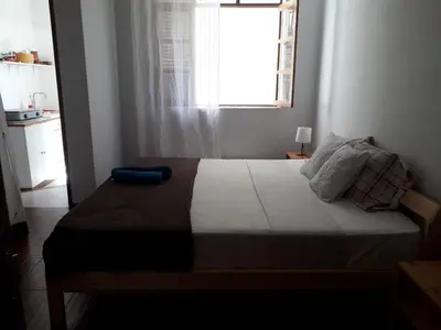 a bedroom with a large bed with a window at Maya Mindelo 2 in Mindelo