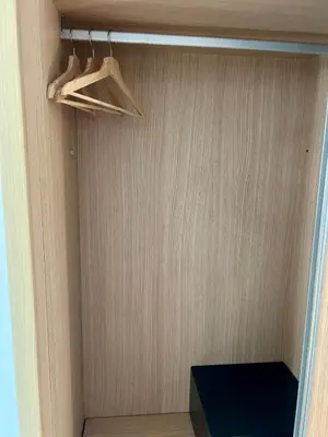 a closet with a wooden door and a shelf at condomínio vila verde Pepper, Cactus T0,T1,T2 in Santa Maria