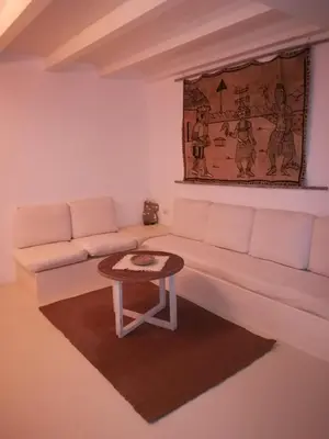 a living room with a white couch and a table at Appartamenti Praia Estoril, Sal Rei, Boa Vista in Sal Rei