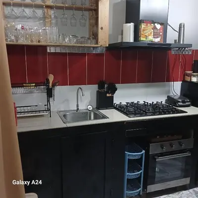 a kitchen with a sink and a stove at Casa brunosky in Mindelo