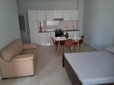 a living room with a couch and a table with chairs at T0 Cabral Next Door in Sal Rei