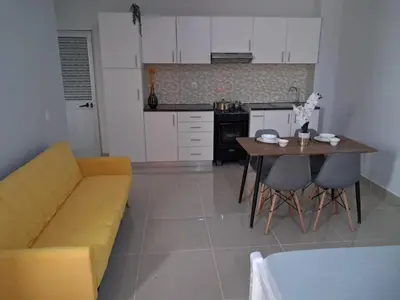 a living room with a couch and a table at T0 Cabral Next Door in Sal Rei