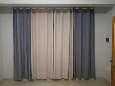 a room with gray and white curtains on a wall at T0 Cabral Next Door in Sal Rei