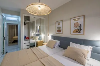 a bedroom with a large bed with a blue headboard at HouseLux JJL in Mindelo