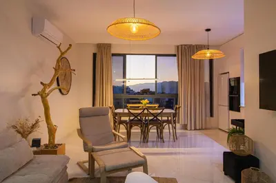 a living room with a table and a dining room at HouseLux JJL in Mindelo