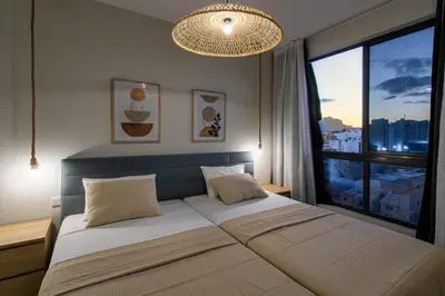 a bedroom with a large bed with a large window at HouseLux JJL in Mindelo