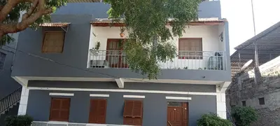 a blue and white building with a balcony at Holiday's House in Praia