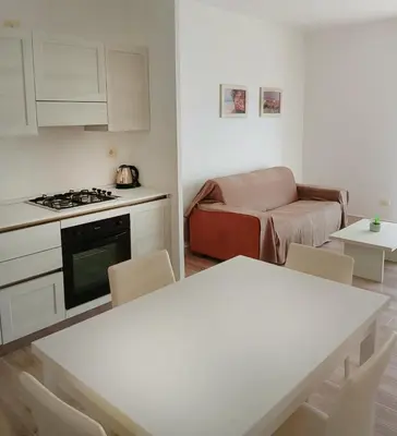 a kitchen and living room with a table and a couch at Onda do Mar in Sal Rei