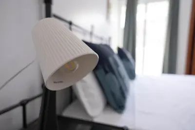 a white lamp sitting on top of a table at Marel Bliss Apartments T2 Lorena in Mindelo