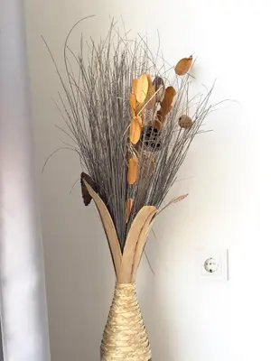 a vase with some dried grasses in it at Spacious 3-bdr apartment - Palmarejo Grande - LCGR in Praia