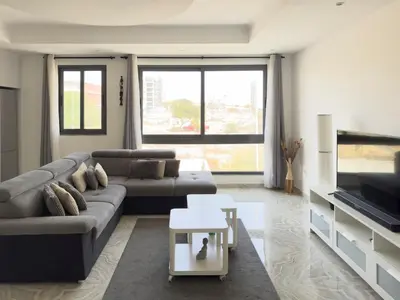 a living room with a couch and a tv at Spacious 3-bdr apartment - Palmarejo Grande - LCGR in Praia