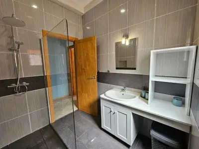 a bathroom with a sink and a shower at Bouganville Holiday Apartment in Santa Maria