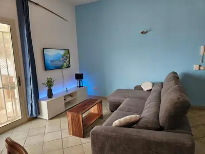 a living room with a couch and a table at Bouganville Holiday Apartment in Santa Maria
