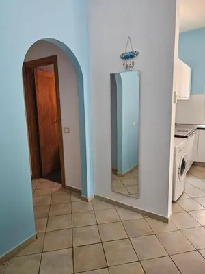 a hallway with a mirror and a door in a kitchen at Bouganville Holiday Apartment in Santa Maria
