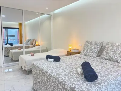 a hotel room with two beds and a mirror at Relax in Praia in comfort in Praia