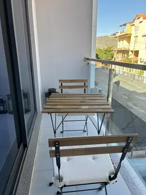 a table and bench on a balcony with a view at Relax in Praia in comfort in Praia