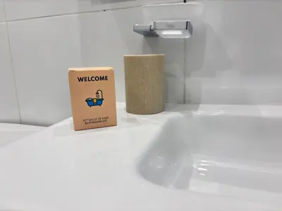 a box sitting on a counter next to a bathroom sink at Relax in Praia in comfort in Praia