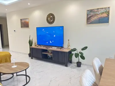 a living room with a large flat screen tv at Relax in Praia in comfort in Praia
