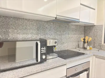 a kitchen with a microwave and a counter top at Relax in Praia in comfort in Praia