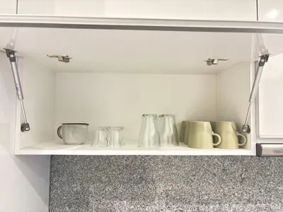 a kitchen shelf with several glass utensils on it at Relax in Praia in comfort in Praia