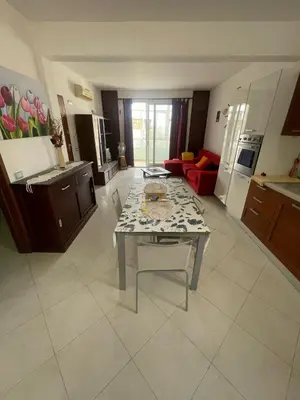 a large kitchen and living room with a table in it at Two Bedroom Apt - 150 meters from the Beach in Santa Maria