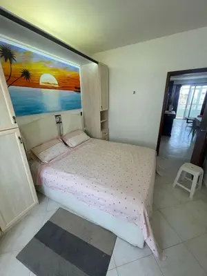 a bedroom with a bed with a painting on the wall at Two Bedroom Apt - 150 meters from the Beach in Santa Maria
