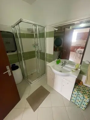 a bathroom with a sink and a shower at Two Bedroom Apt - 150 meters from the Beach in Santa Maria