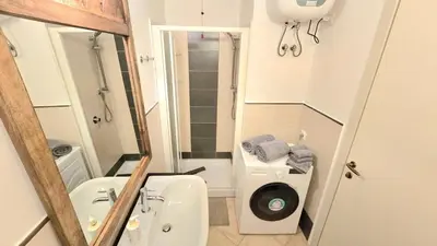 a small bathroom with a toilet and a sink at T&C No Stress apartment in Santa Maria