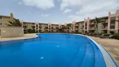 a large swimming pool in front of some apartments at T&C No Stress apartment in Santa Maria