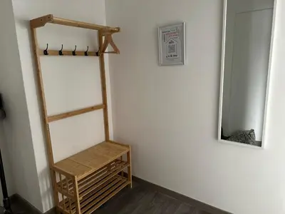 a room with a shelf and a mirror on a wall at Cozy Flat in Praia