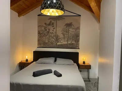 a bedroom with a bed with two black towels on it at Island Retreat in Santa Maria